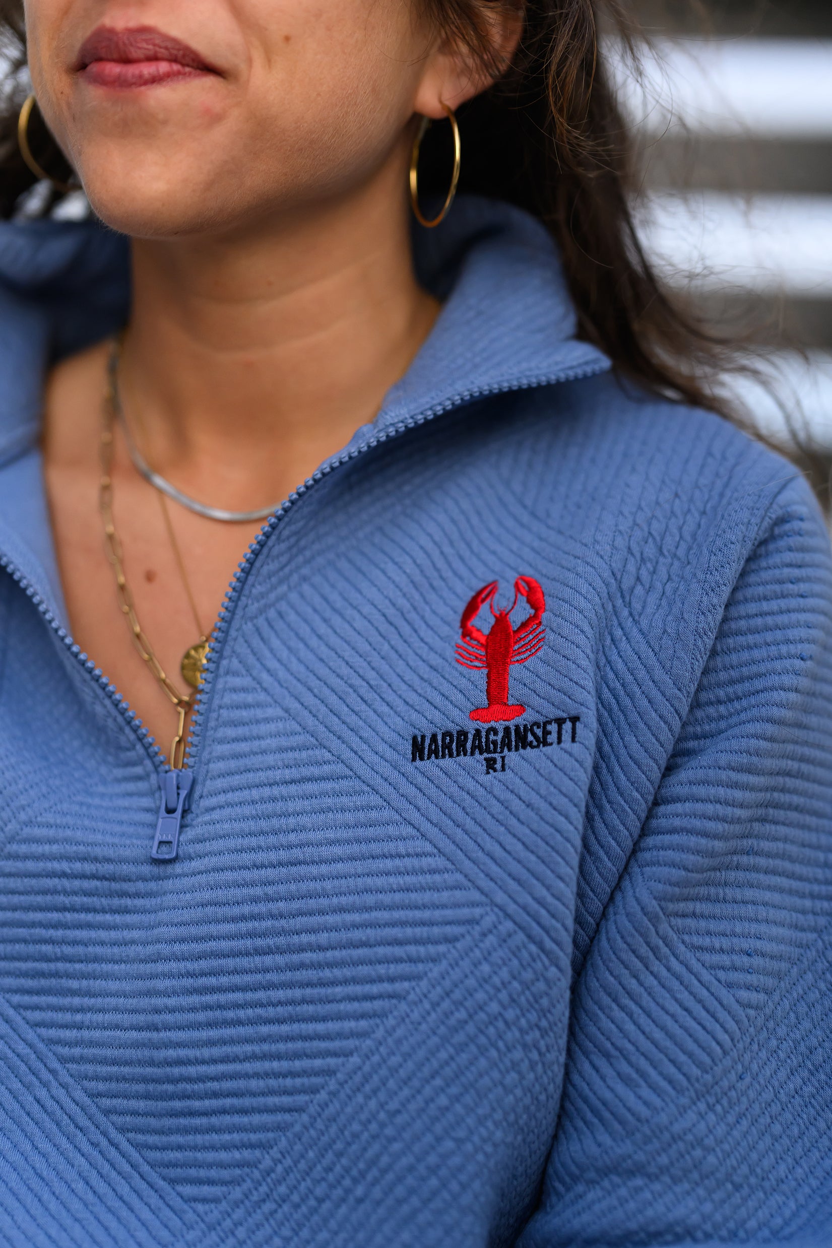 Coastal Lobster Quarter Zip in soft blue. Embroidered lobster with Narragansett RI text on textured knit fabric.